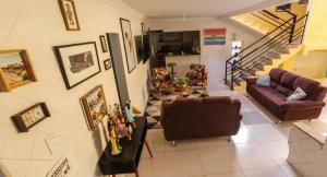 uma sala de estar com um sofá e uma escada em RioSlz Hostel em São Luís