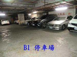 a group of cars parked in a parking garage at Modern Plaza Hotel in Kaohsiung