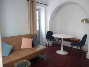 a living room with a couch and a table at Penamacor Cozy Nook House in Penamacor