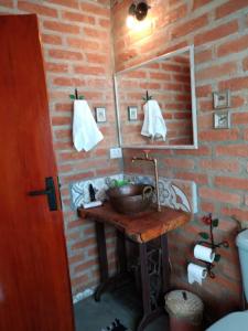 a bathroom with a sink and a mirror at Chalé charmoso com vista p/ Montanha - Gonçalves in Paraisópolis