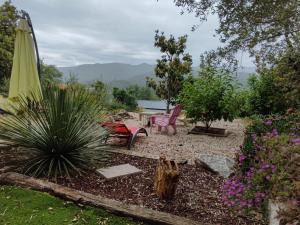 a patio with a table and chairs and an umbrella at appartement coubillou in Lamalou-les-Bains