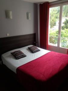 a bedroom with a large bed with a window at Auberge de Barnas in Barnas