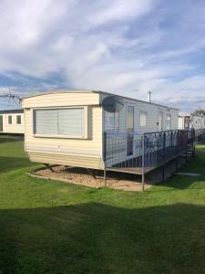 a mobile home is parked in a field at Caravan holiday let 2 bedroom happy days SOUTH chapel saint Leonards 05 in Chapel Saint Leonards