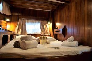 a bedroom with a large bed with towels on it at DonnaMarisa in Palermo