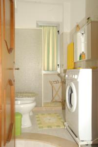 a bathroom with a washer and dryer in it at GB Case Vacanze Sicilia in Balestrate +144 photos