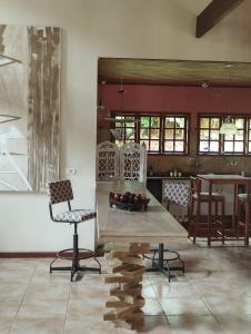 a living room with a table and a chair at Chalés JARDIM-REAL in Lumiar