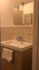 y baño con lavabo blanco y espejo. en SAN FELICE ROOMS en Bolonia