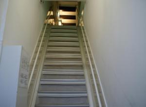 a staircase in a building with a ladder at Hotel Prinsenhof Amsterdam in Amsterdam