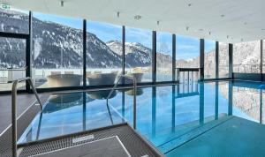 a swimming pool in a building with mountains at haldensee - Naturerlebnis und Wellnesshotel in Nesselwängle