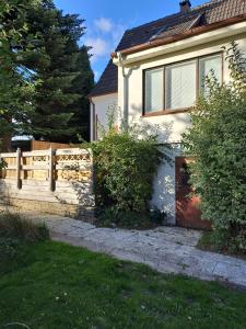 a white house with a fence and a gate at FerienhausWeseby in Hürup
