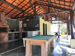a ping pong table in the middle of a room at Casa com piscina em Aldeia Velha in Quartéis