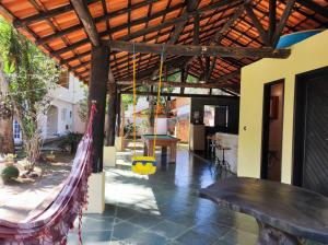 a patio with a hammock hanging from a house at Casa com piscina em Aldeia Velha in Quartéis
