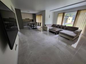 a living room with a couch and a table at Vomikay Villa in Tallinn