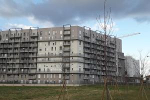 a large apartment building with trees in front of it at SKYLINE MILANO Fiera in Milan