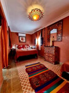 um quarto com uma cama e um lustre em Riad Andalla em Marrakech