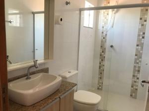 a bathroom with a sink and a toilet and a shower at Pousada Souza & Souza in Barra Velha