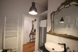 a bathroom with a sink and a mirror at Il Chiostro in Cagliari