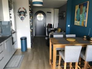 a kitchen and dining room with a table and chairs at charmant studio vue mer in Wimereux