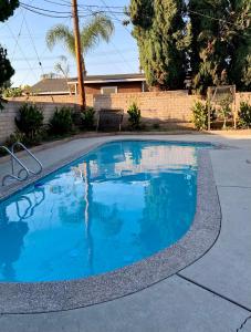 einen Pool mit blauem Wasser in einer Einfahrt in der Unterkunft Cheers Hostel in Los Angeles
