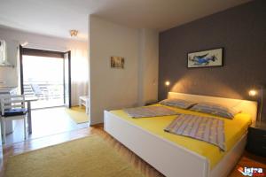 Posteľ alebo postele v izbe v ubytovaní Dr. IGDA Apartments