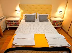 a large bed in a room with two night stands at La Casa de las Nereidas in Cuenca