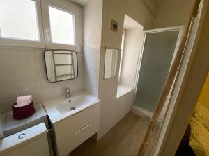a bathroom with a sink and a mirror and a shower at Bandol plage port in Bandol +9 photos