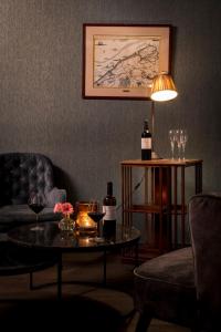 a living room with a couch and a table with wine glasses at B&B l'histoire de l'éclair in Bruges +65 photos