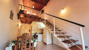 a staircase in a room with a kitchen and a kitchen at Cálido Rincón in Villa Elisa +16 photos