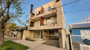 an apartment building with a balcony on a street at Cálido Rincón in Villa Elisa
