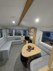 a living room with a couch and a table at KEE Holiday Home Caravan in Great Yarmouth