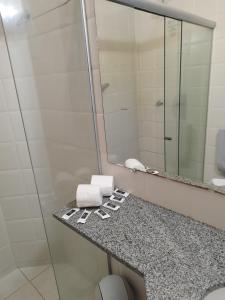 a bathroom with a sink and a mirror at Apart Boulevard da Praia 155D in Porto Seguro