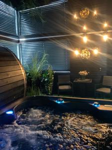 a hot tub in a garden at night with lights at Lans Apartments SPA Menden Sauerland in Menden