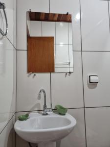 a bathroom with a sink and a mirror at Estalagem Do Luar in Monte Verde +28 photos