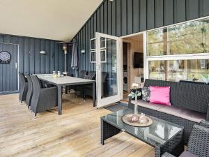 a living room with a couch and a table at 8 person holiday home in Blokhus-By Traum in Blokhus