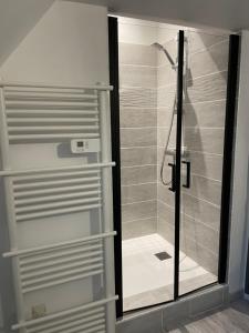 a shower in a bathroom with a glass door at Villa avec jaccuzi in Noailhac