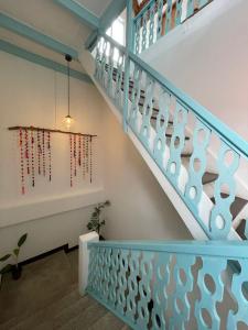 a staircase with blue and white railings and a window at Casa Ramona in Flores +42 photos