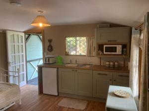 a kitchen with a sink and a microwave at Cherry Croft Lodge in Little Singleton