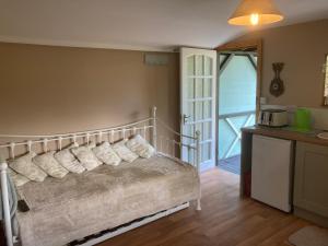 a bedroom with a bed with pillows on it at Cherry Croft Lodge in Little Singleton