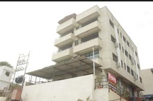 a building under construction on a city street at Primrose Guest House in Pune