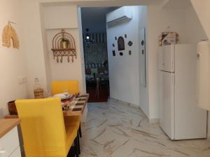 a kitchen with a table and a white refrigerator at San Amador in Martos