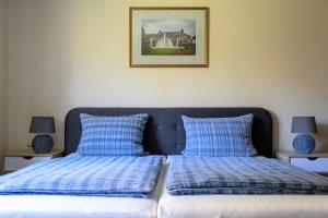 1 dormitorio con 2 camas y almohadas azules y blancas en Ferienwohnung Bad Kissingen en Bad Kissingen
