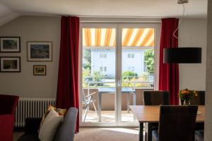 a living room with a sliding glass door with a table at Ferienwohnung Bad Kissingen in Bad Kissingen