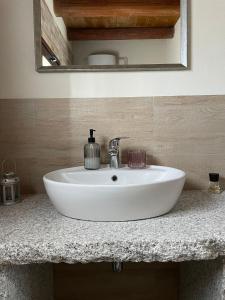 a white sink on a counter in a bathroom at La Casetta in San Nicolò dʼArcidano