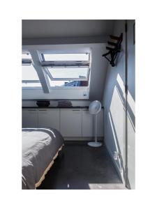 a bedroom with a window and a bed in it at Central Perk Apartments-Antwerp in Antwerp