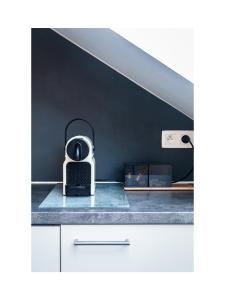 a kitchen counter with a toaster sitting on top of it at Central Perk Apartments-Antwerp in Antwerp