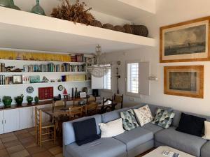 a living room with a couch and a dining room at Es Forn - Cadaqués in Cadaqués