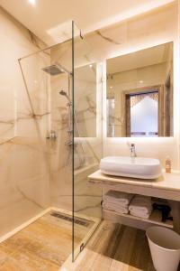 a bathroom with a shower and a sink at Riad Zyo in Rabat