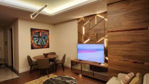 a living room with a tv and a table at High Residence -Monthly rental- Mall of Istanbul in Istanbul
