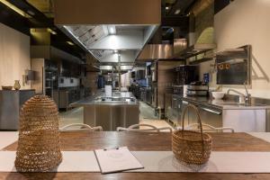 a large kitchen with a wooden table and chairs at Masseria Le Mandorle in Ugento