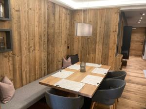 a dining room with a wooden table and chairs at Lodge14 in Kirchberg in Tirol